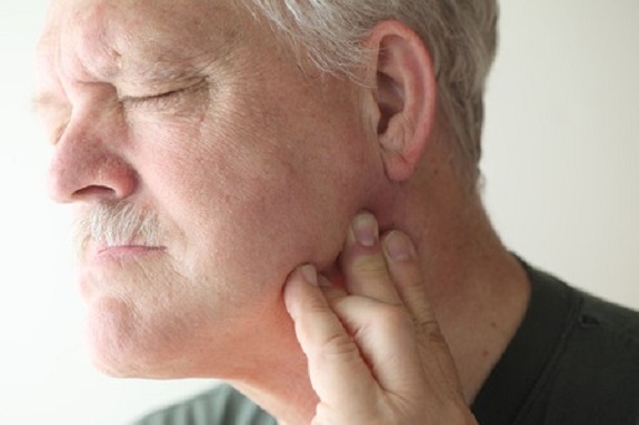 Is it better to see a doctor or a dentist when experiencing TMJ pain?